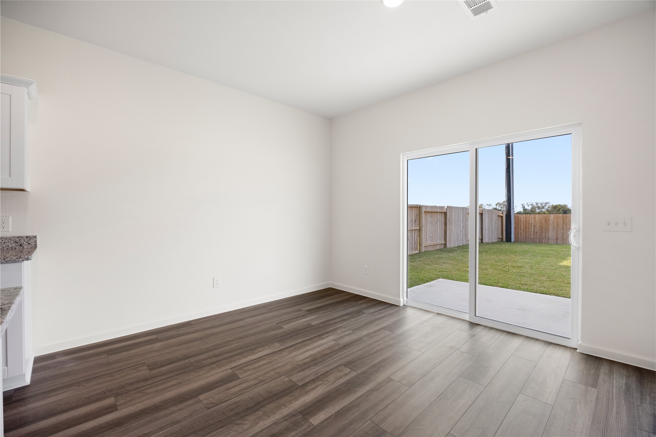 8807 Vacek Xing Way Richmond, TX 77469 - Photo 30 of 33 a view of an empty room with wooden floor