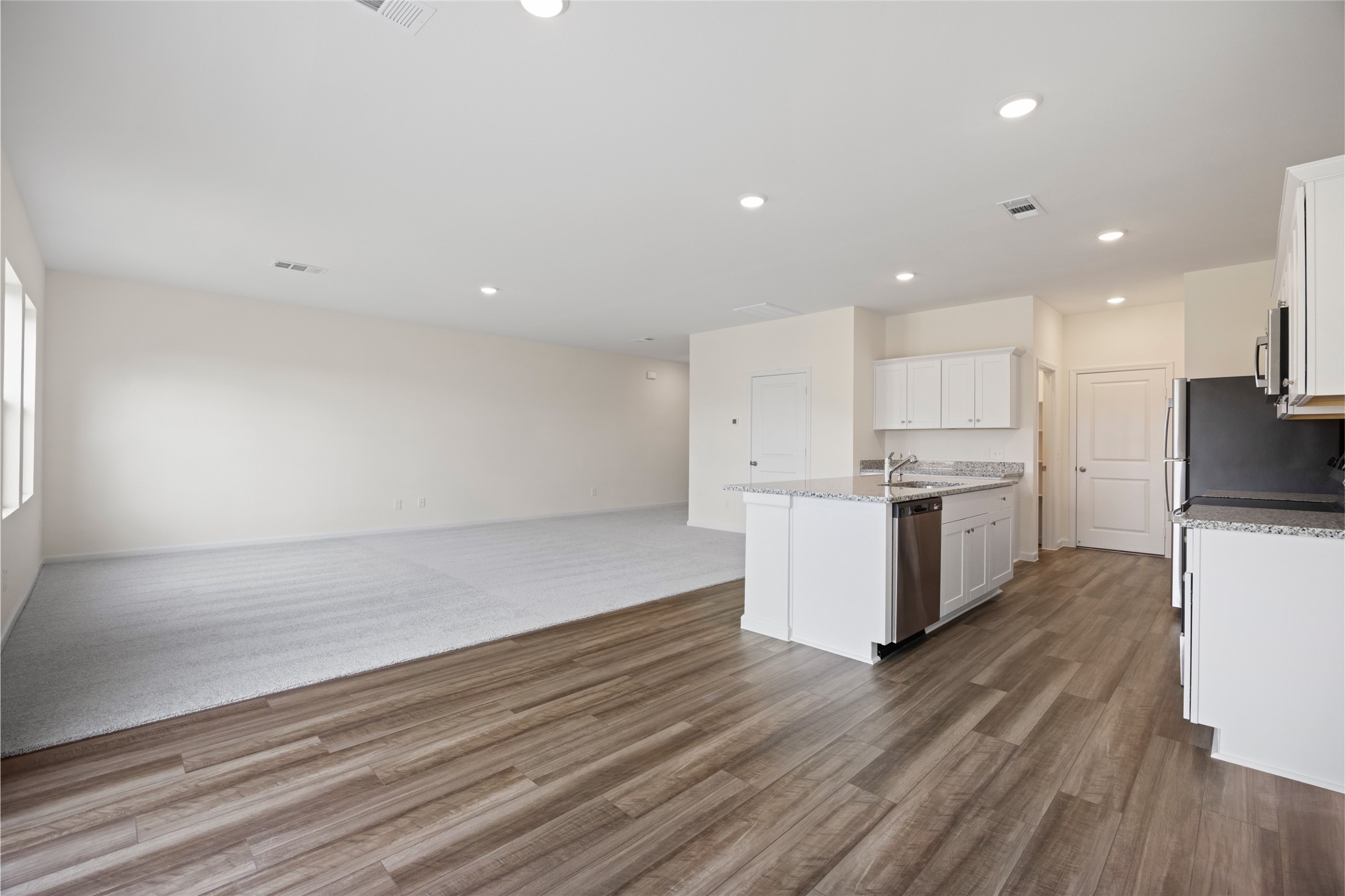 8807 Vacek Xing Way Richmond, TX 77469 - Photo 31 of 33 a large kitchen with stainless steel appliances a large counter top a stove and a refrigerator