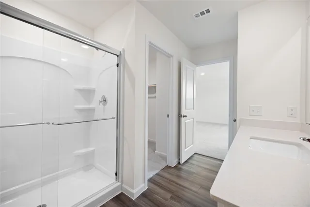 a bathroom with a glass shower door