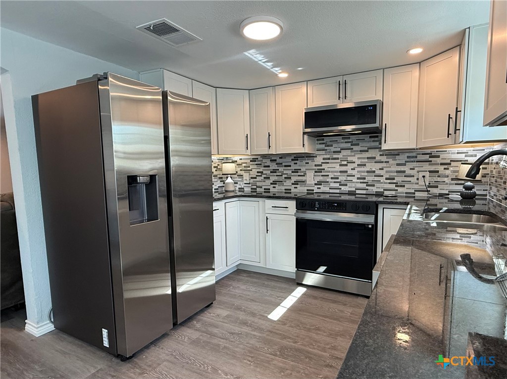8 Marshall Road Port Lavaca, TX 77979 - Photo 11 of 31 a kitchen with a refrigerator sink and cabinets