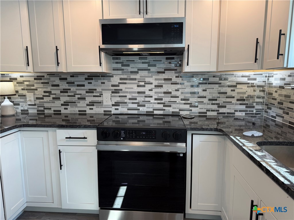 8 Marshall Road Port Lavaca, TX 77979 - Photo 12 of 31 a kitchen with stainless steel appliances granite countertop a stove a sink and a microwave