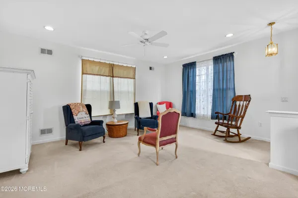 a living room with furniture and floor to ceiling window
