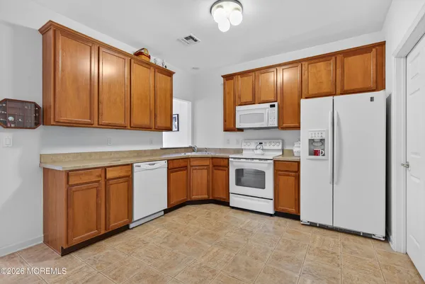 a kitchen with stainless steel appliances a refrigerator sink and cabinets