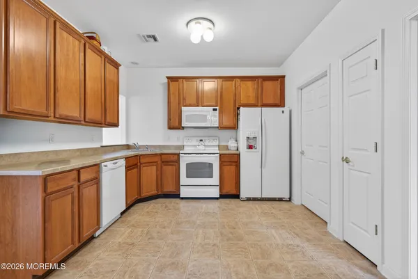 a kitchen with stainless steel appliances granite countertop a refrigerator sink and cabinets