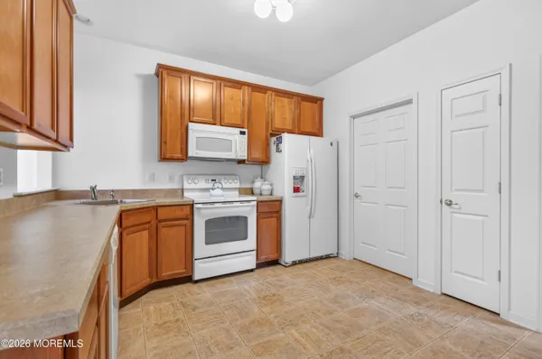 a kitchen with stainless steel appliances a refrigerator sink and cabinets