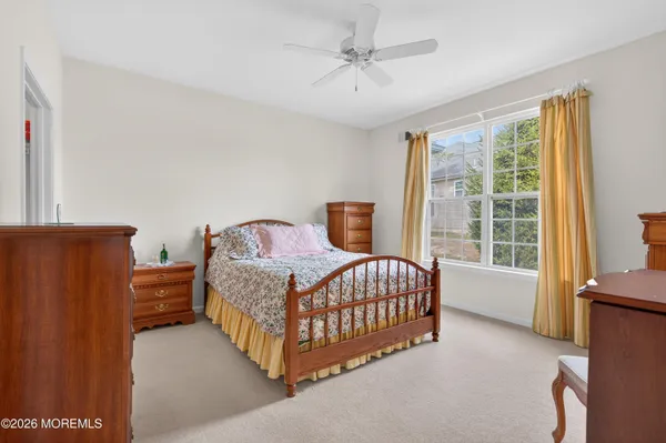a bedroom with a bed lamp and a window