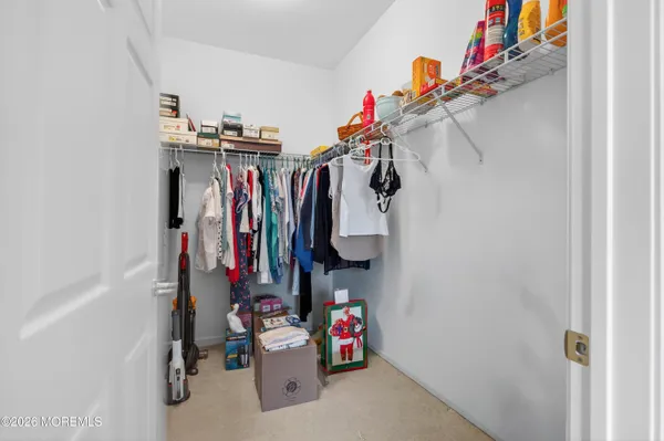 a view of walk in closet with clothes