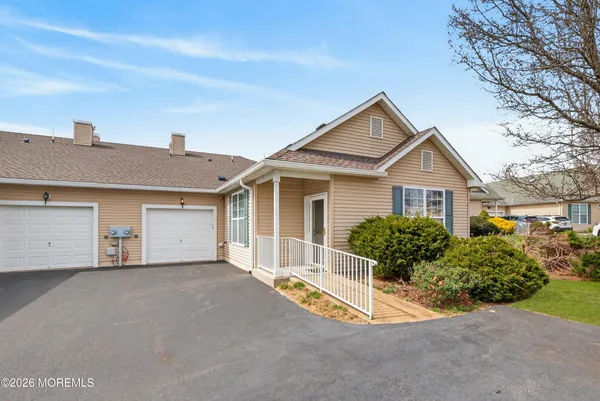 a view of a house with a yard and garage