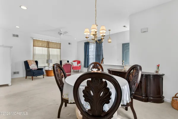 a view of a dining room with furniture and chandelier