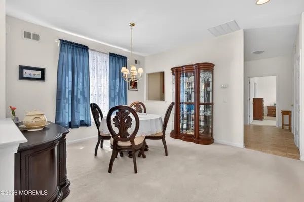 a dining room with furniture and window