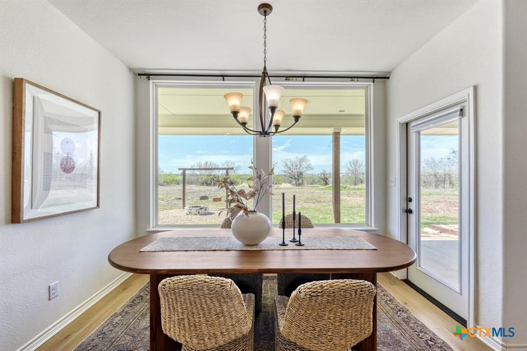 1642 Scull Road San Marcos, TX 78666 - Photo 8 of 31 Dining area framed by expansive landscape views.