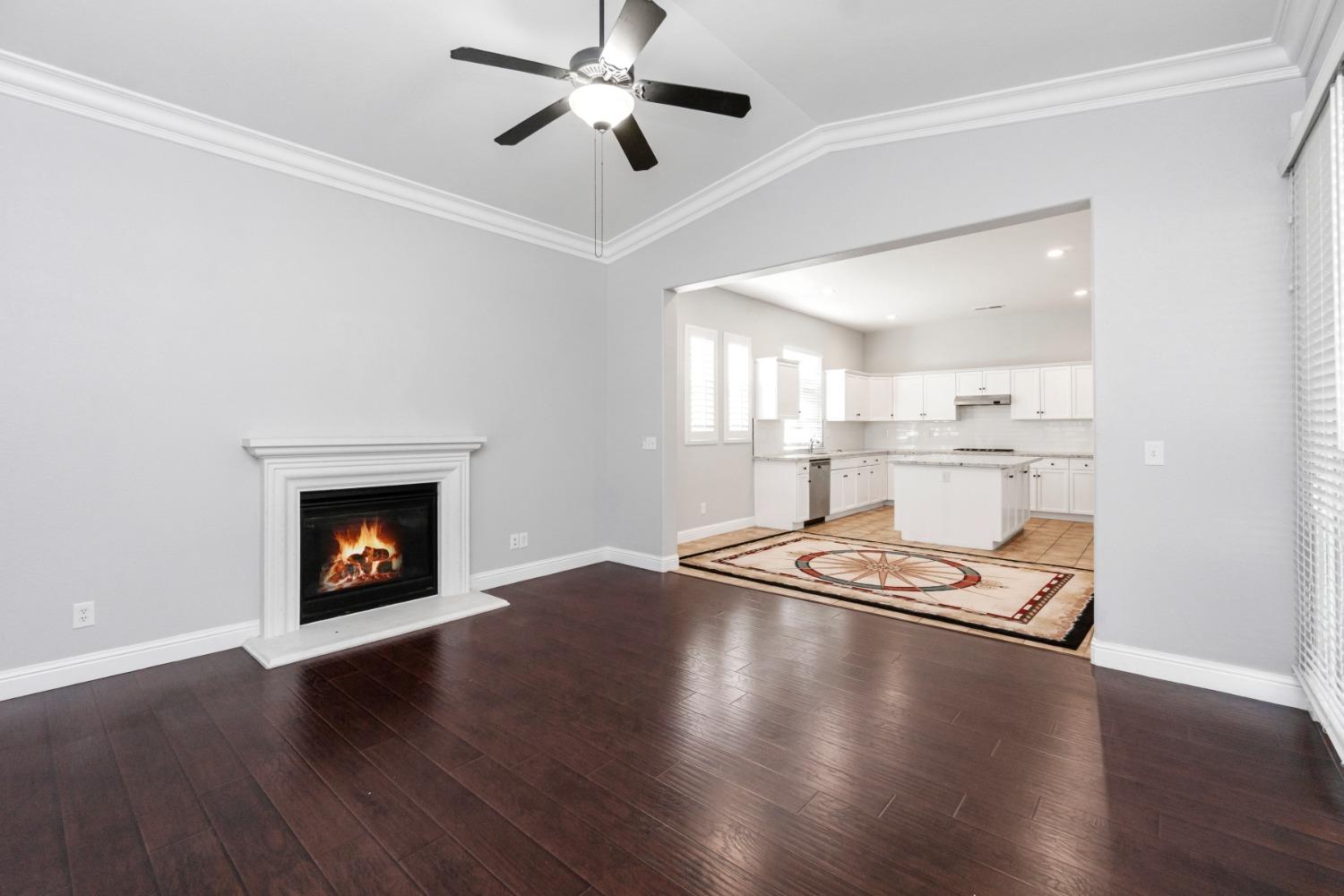 3307 Buckingham Avenue Clovis, CA 93619 - Photo 12 of 32 a open hall with wooden floor and a fireplace