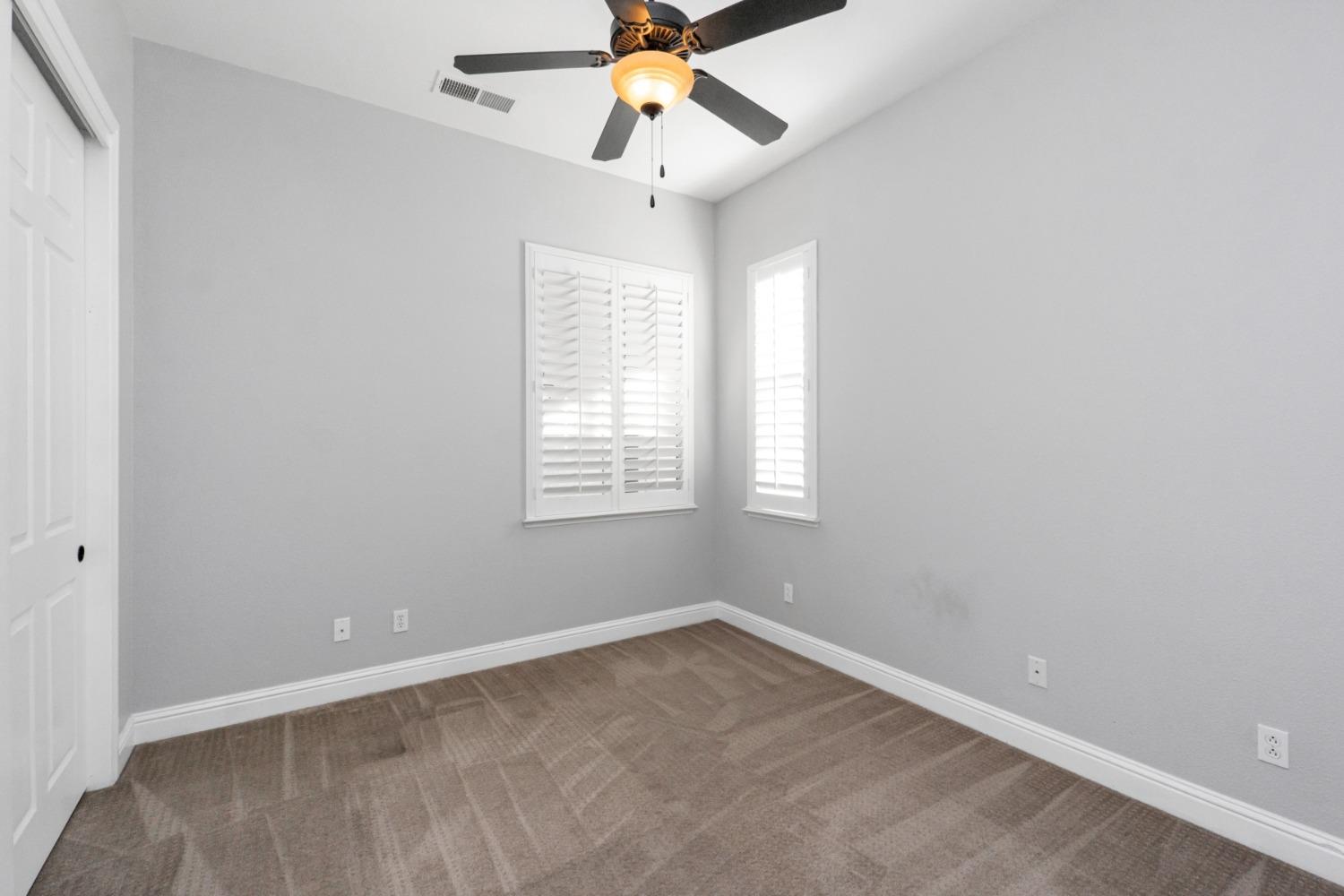 3307 Buckingham Avenue Clovis, CA 93619 - Photo 14 of 32 an empty room with a window and a fan