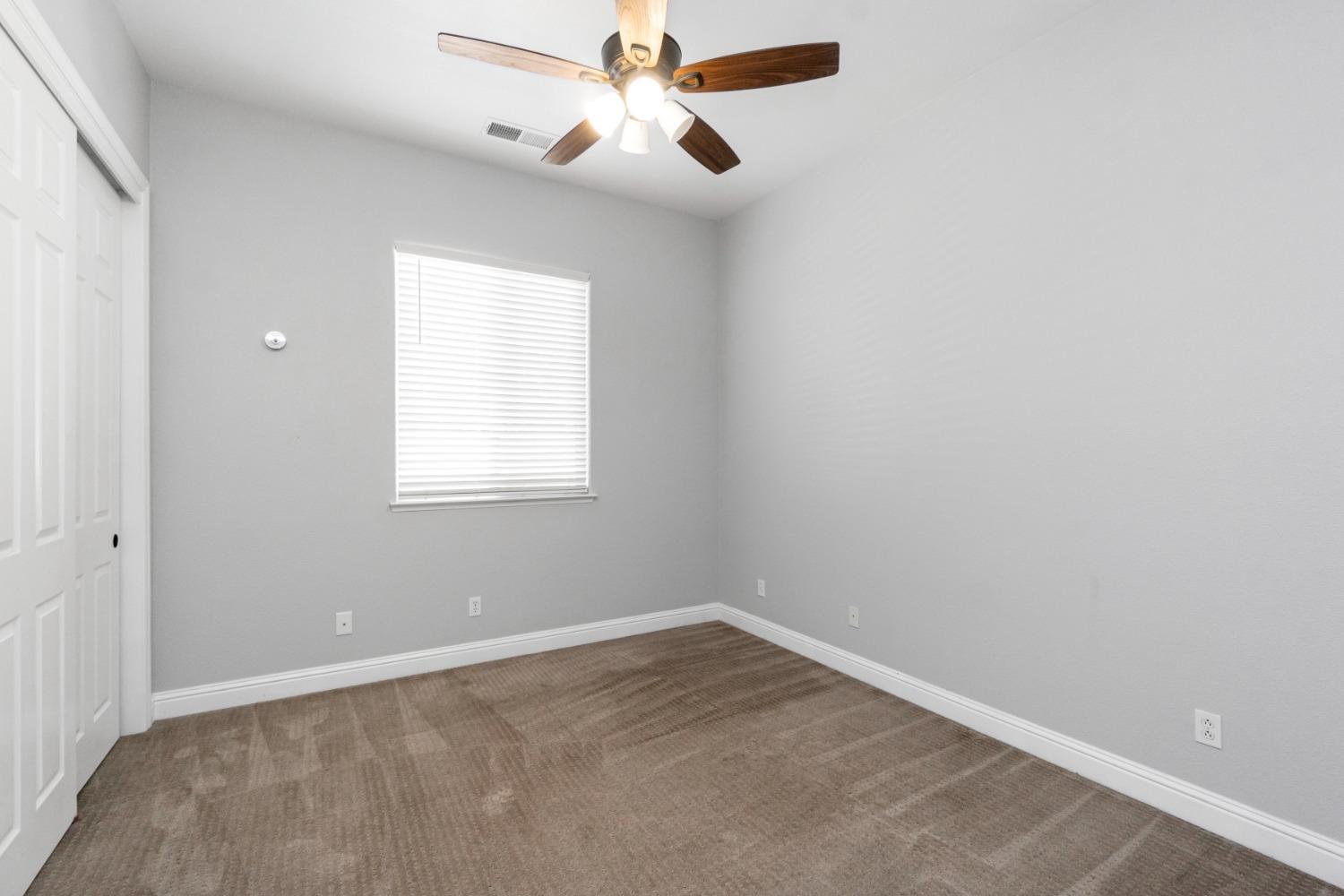 3307 Buckingham Avenue Clovis, CA 93619 - Photo 16 of 32 an empty room with a window and a fan