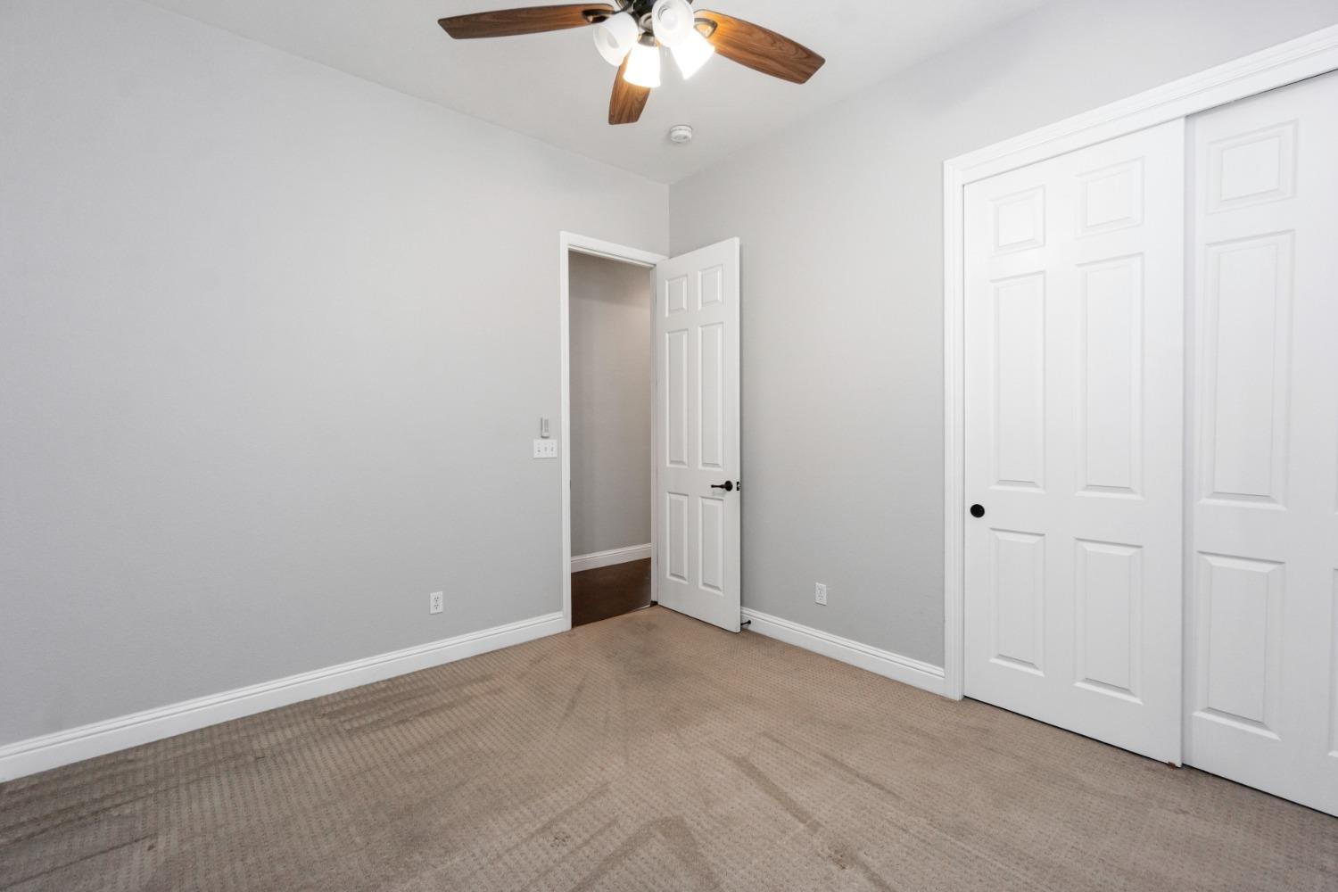 3307 Buckingham Avenue Clovis, CA 93619 - Photo 17 of 32 an empty room with a chandelier fan