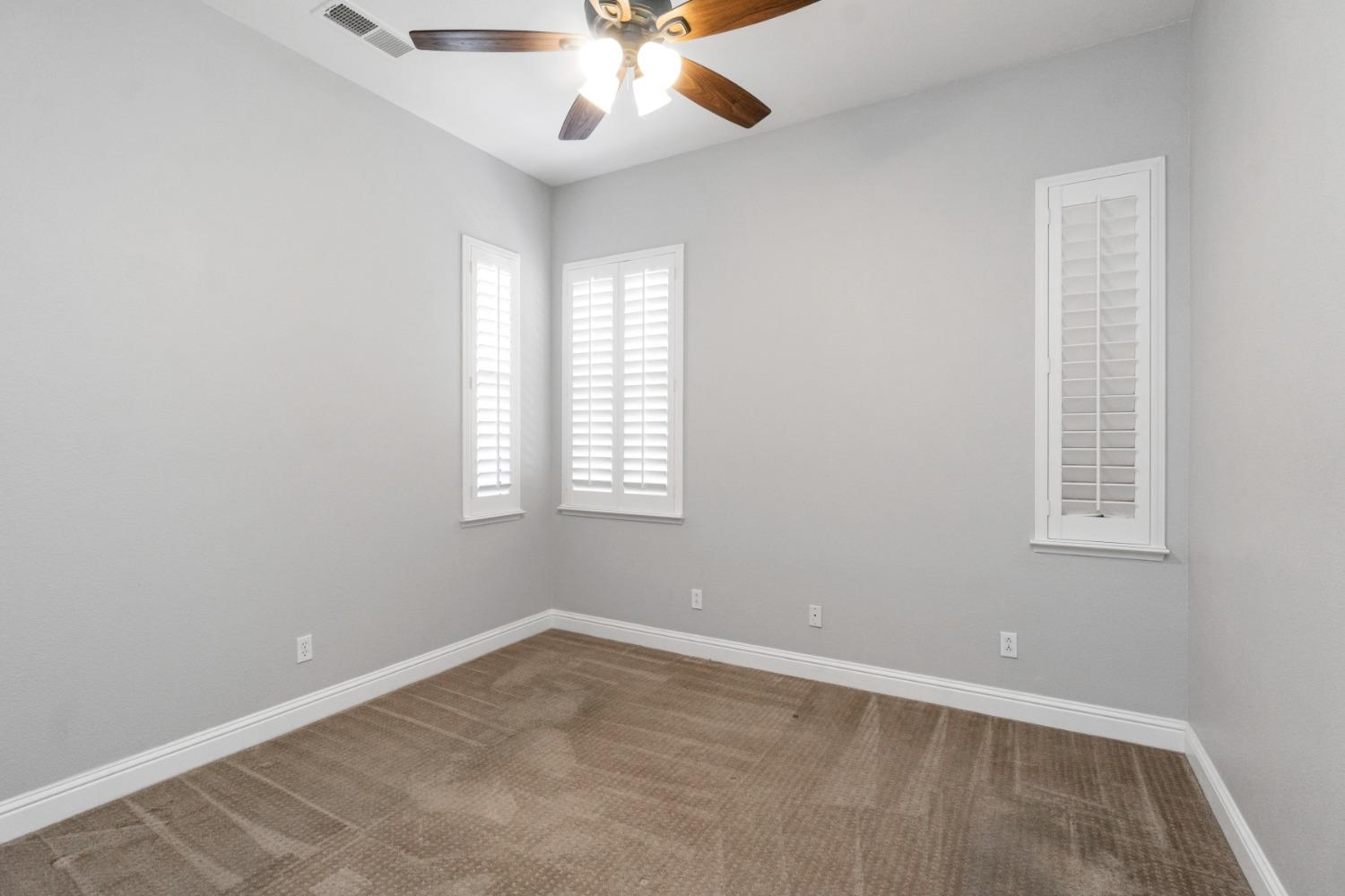 3307 Buckingham Avenue Clovis, CA 93619 - Photo 18 of 32 an empty room with windows and fan