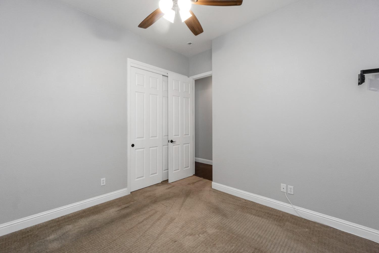 3307 Buckingham Avenue Clovis, CA 93619 - Photo 19 of 32 an empty room with a chandelier fan