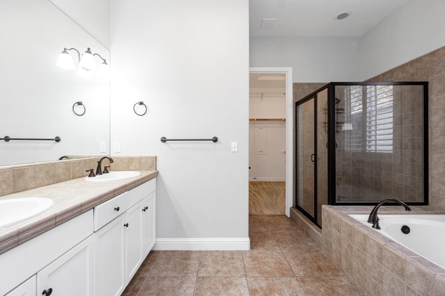 3307 Buckingham Avenue Clovis, CA 93619 - Photo 26 of 32 a bathroom with a double vanity sink mirror and shower