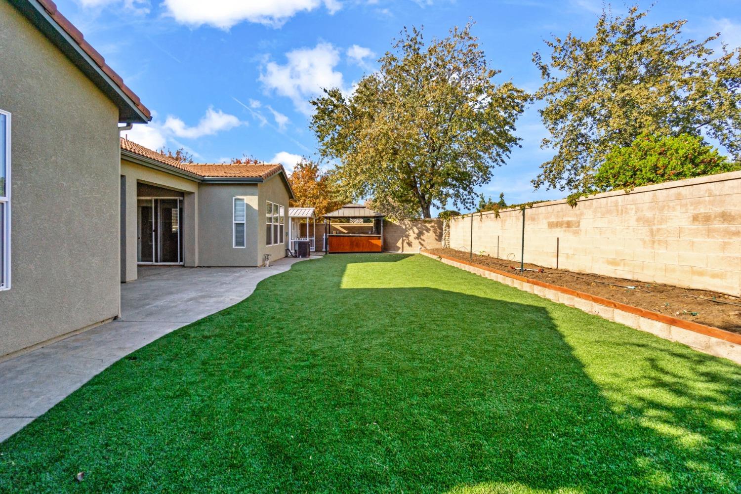3307 Buckingham Avenue Clovis, CA 93619 - Photo 28 of 32 a view of a backyard with a garden and plants