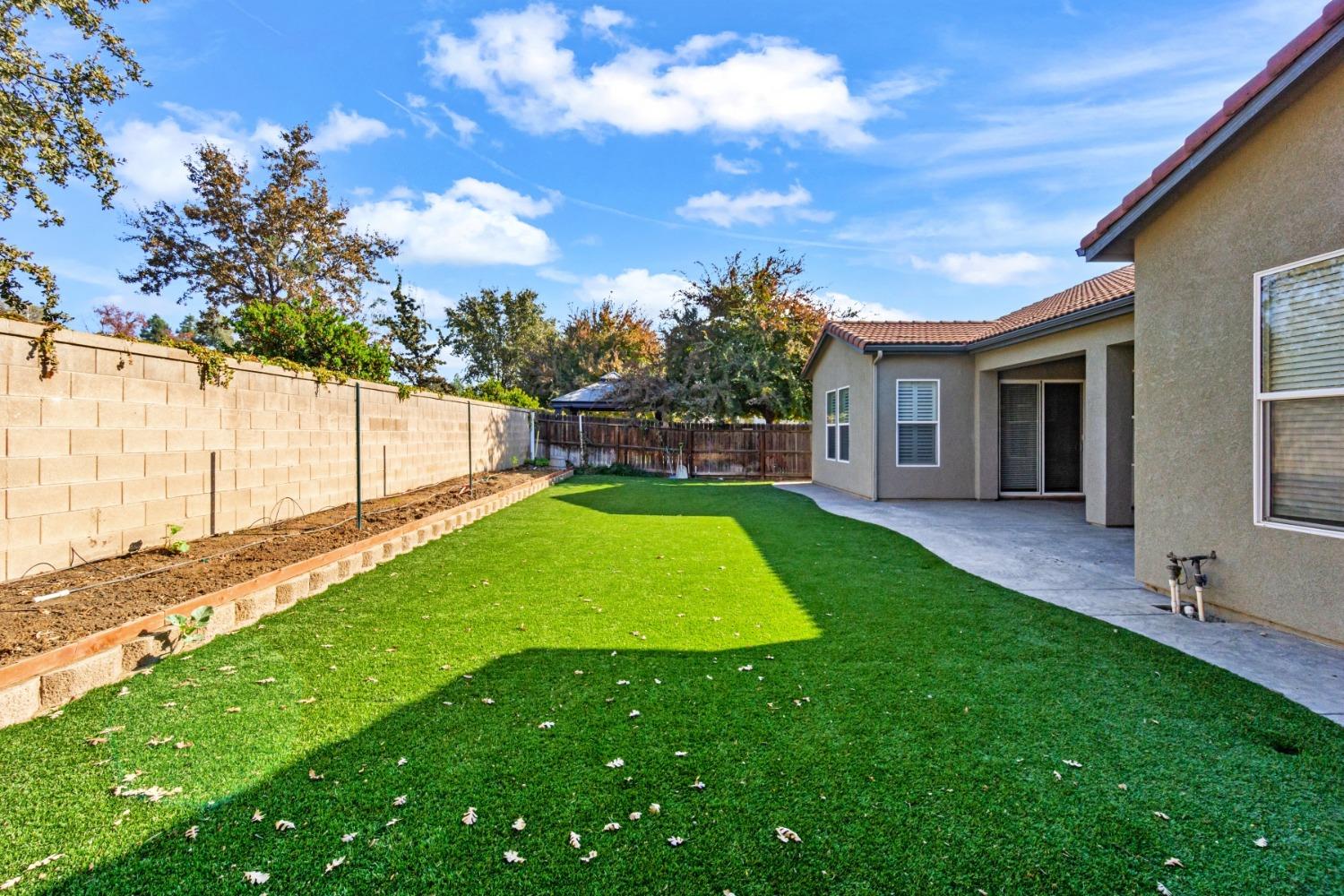 3307 Buckingham Avenue Clovis, CA 93619 - Photo 29 of 32 a view of yard with swimming pool and green space
