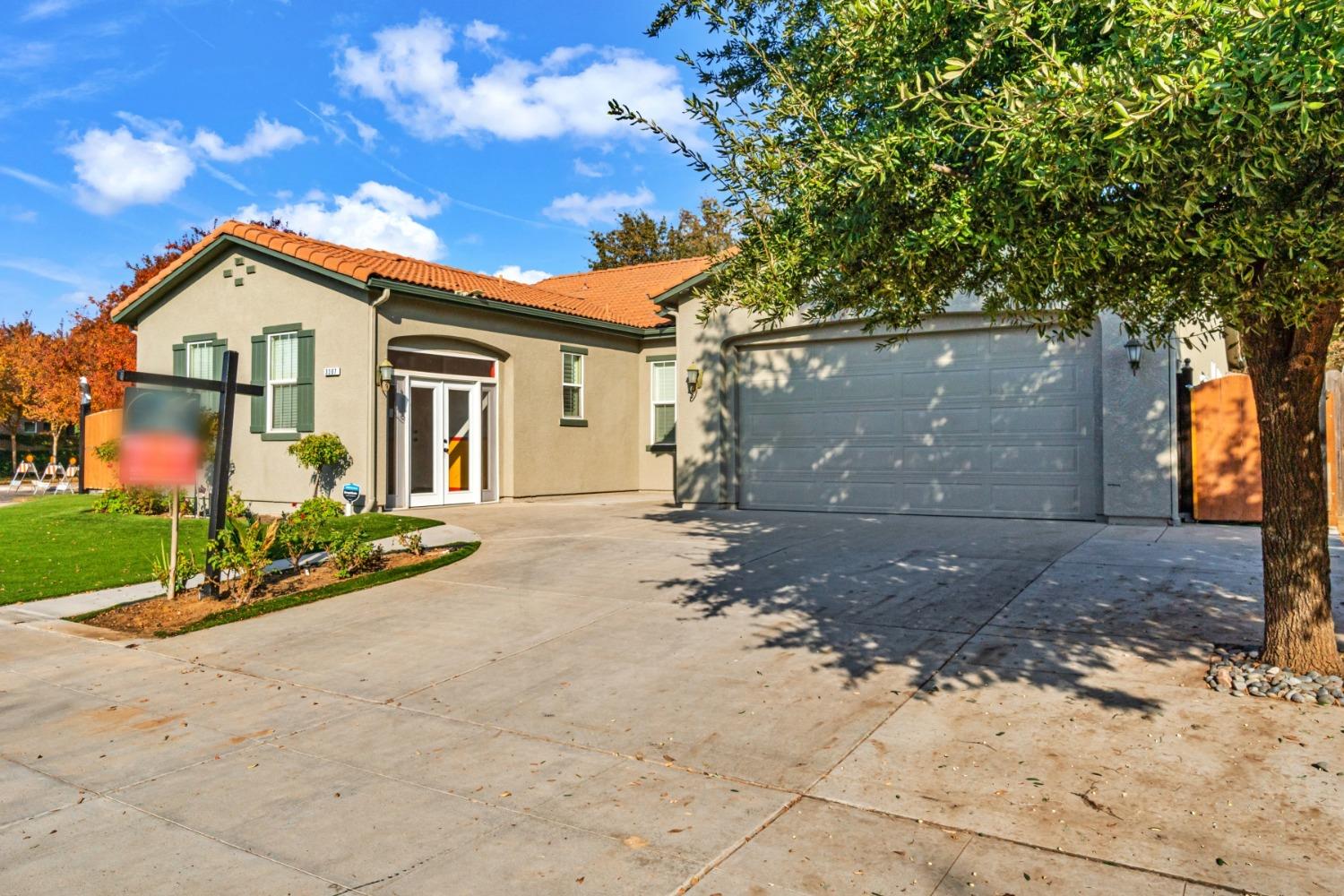 3307 Buckingham Avenue Clovis, CA 93619 - Photo 3 of 32 a view of a house with a yard and large tree