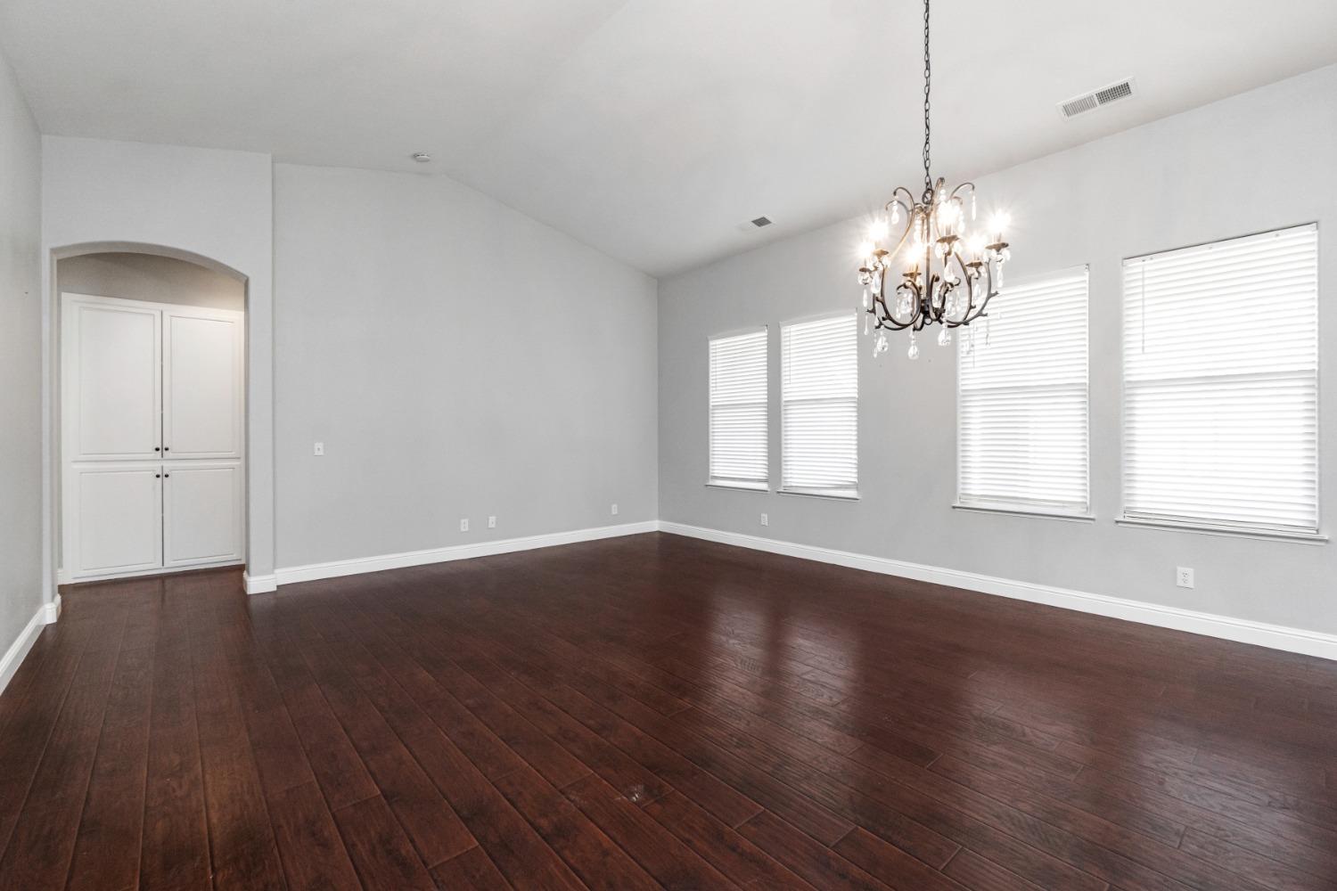 3307 Buckingham Avenue Clovis, CA 93619 - Photo 5 of 32 a view of an empty room with wooden floor and a window
