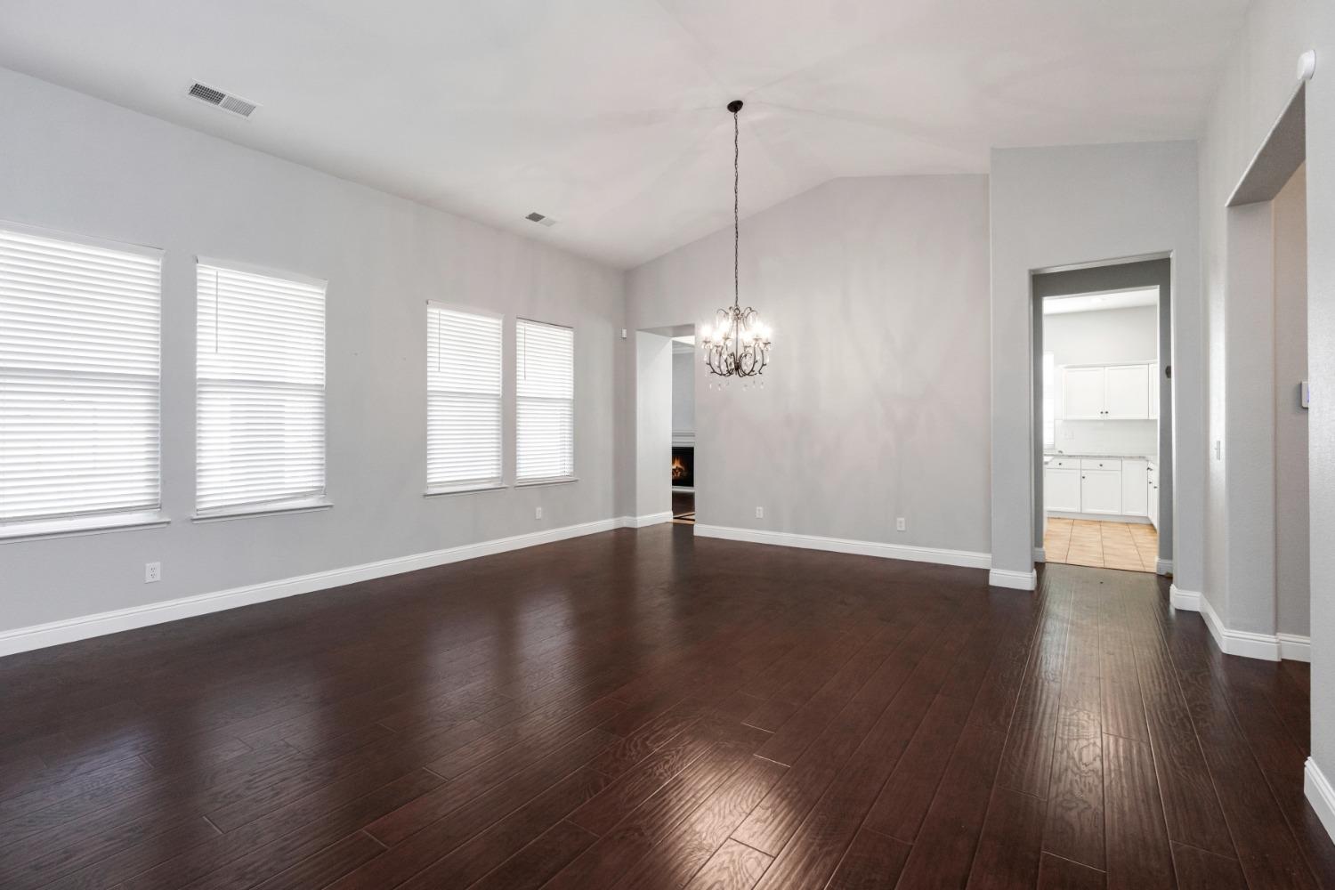 3307 Buckingham Avenue Clovis, CA 93619 - Photo 7 of 32 a view of an empty room with wooden floor and a window