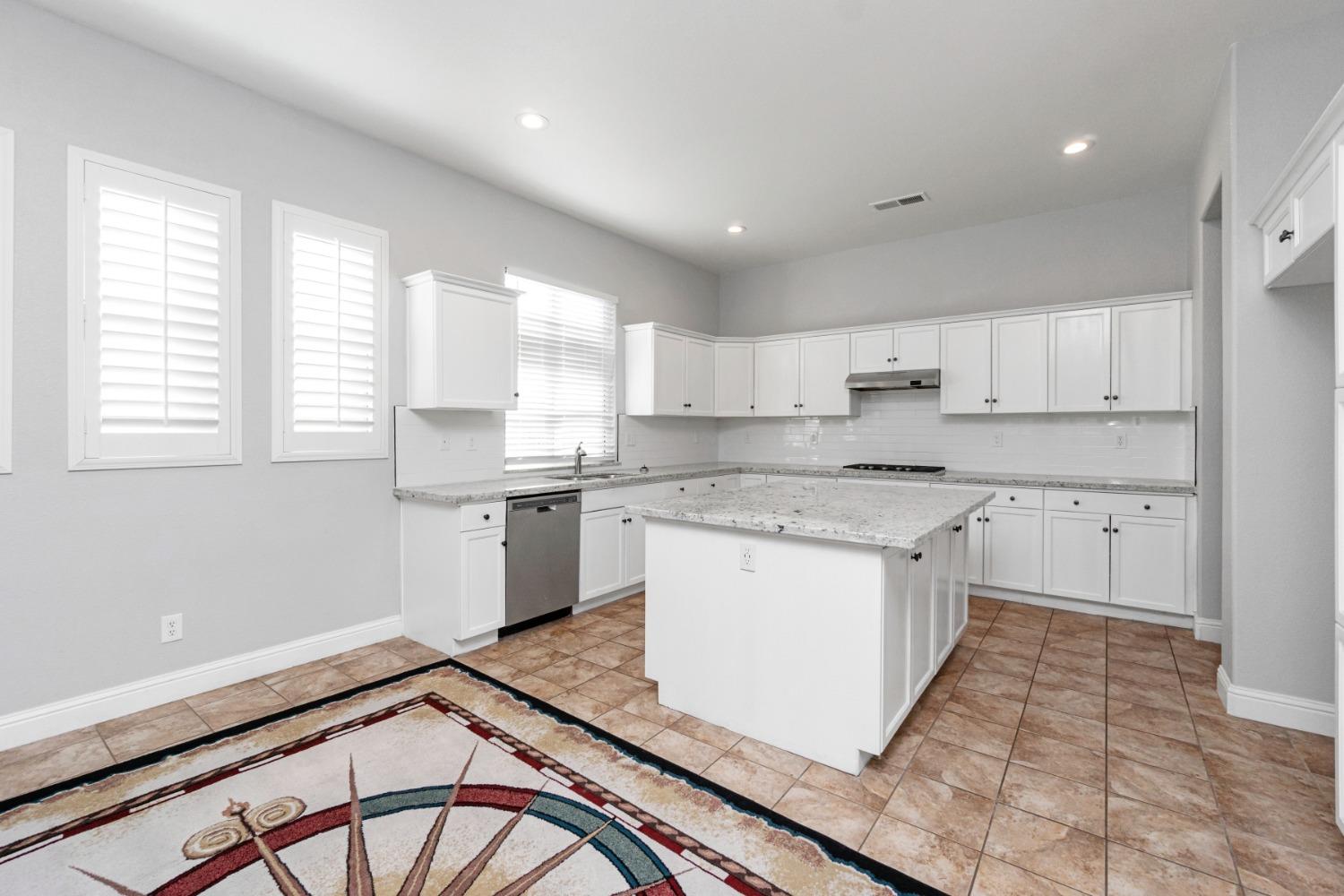 3307 Buckingham Avenue Clovis, CA 93619 - Photo 8 of 32 a kitchen with a sink stove and cabinets