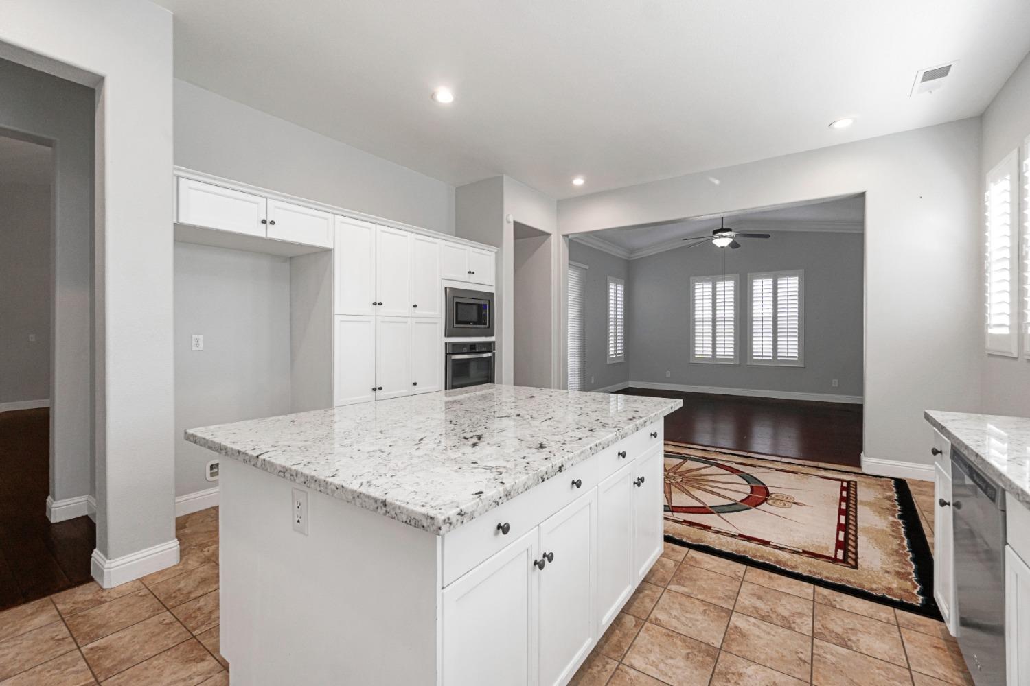 3307 Buckingham Avenue Clovis, CA 93619 - Photo 10 of 32 a view of kitchen island a sink wooden floor dining table and chairs