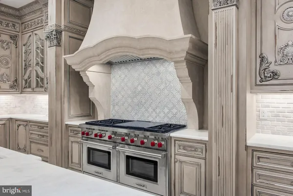 a large white kitchen with a large window