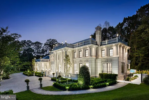 a front view of a residential houses with yard and green space