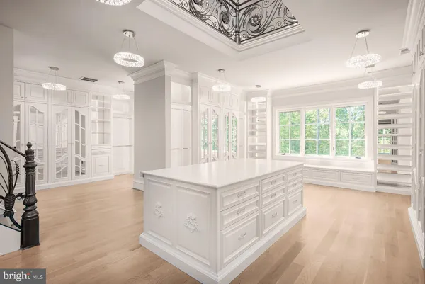 a kitchen with stainless steel appliances a sink cabinets and wooden floor