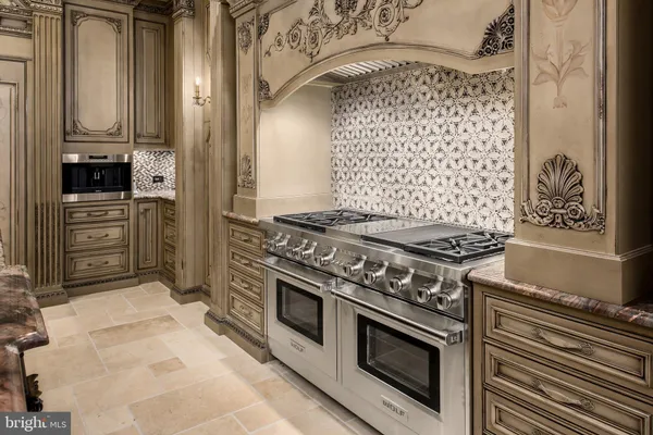 a large white kitchen with a large window