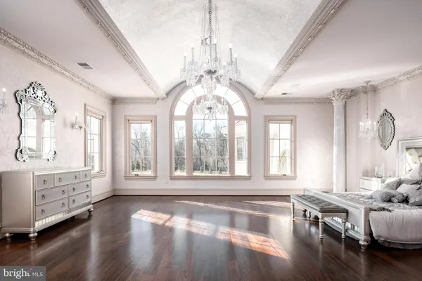 a hall with kitchen island granite countertop a chandelier