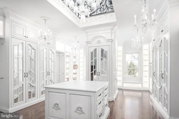 a kitchen with stainless steel appliances kitchen island granite countertop a table chairs and a chandelier