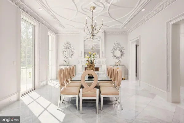 a dining room with furniture a chandelier and window