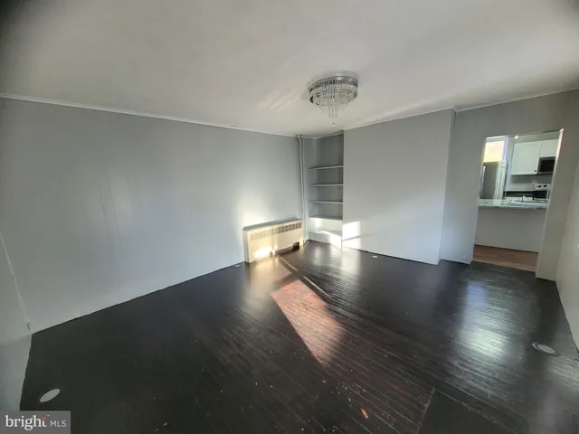 a view of a room with wooden floor