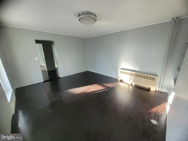 a view of a livingroom with wooden floor and a staircase