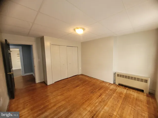 a view of an empty room and wooden floor