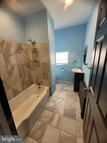 a bathroom with a bathtub sink and toilet