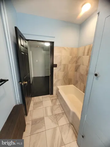 a bathroom with a bathtub and shower