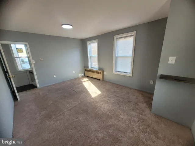 a view of empty room with window and stairs