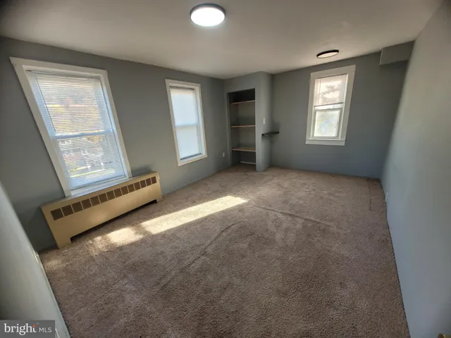 a view of an empty room with windows