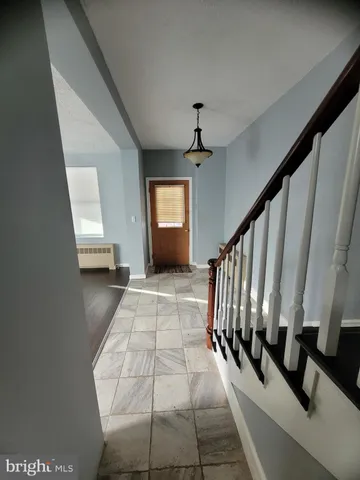 a view of an entryway with wooden floor
