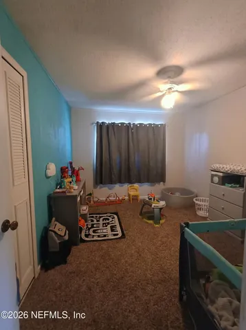 a bedroom with a bed and a mirror