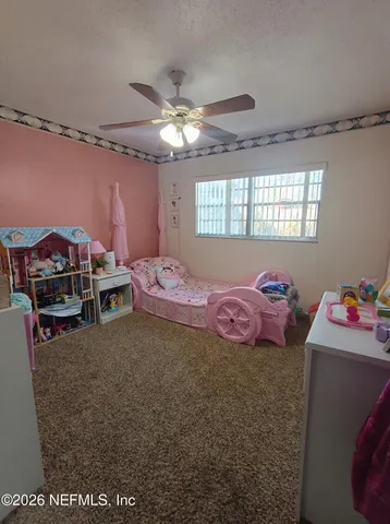 a bedroom with furniture and a chandelier
