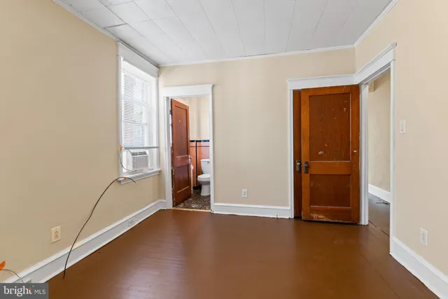 an empty room with windows and closet