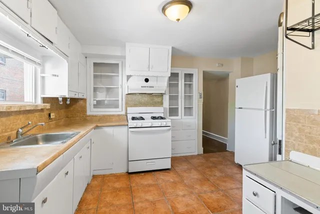 a kitchen with a sink stove and refrigerator