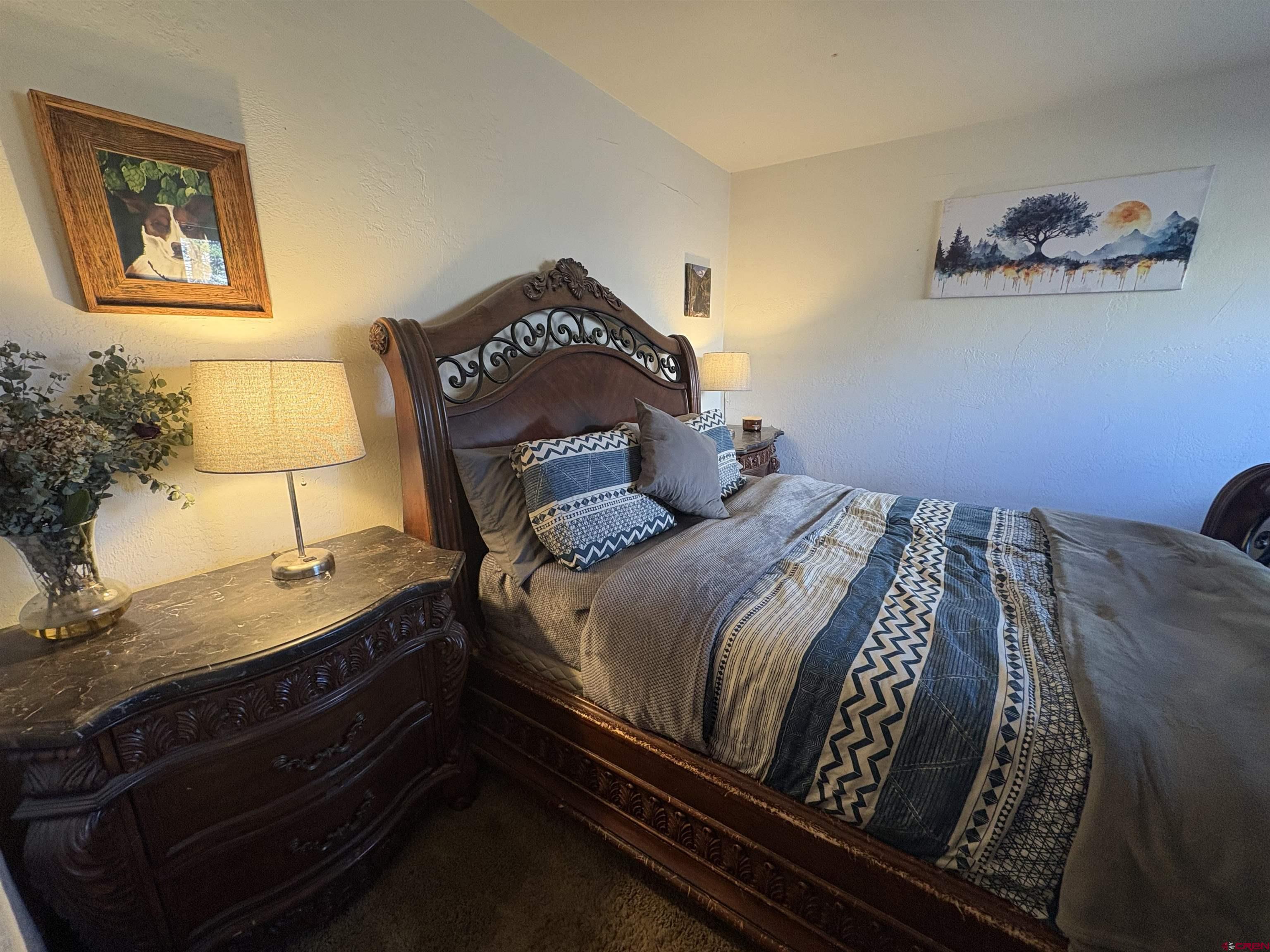 26 Castle Road, Unit 3 Crested Butte, CO 81225 - Photo 25 of 32 a bedroom with a bed and a potted plant on the dresser