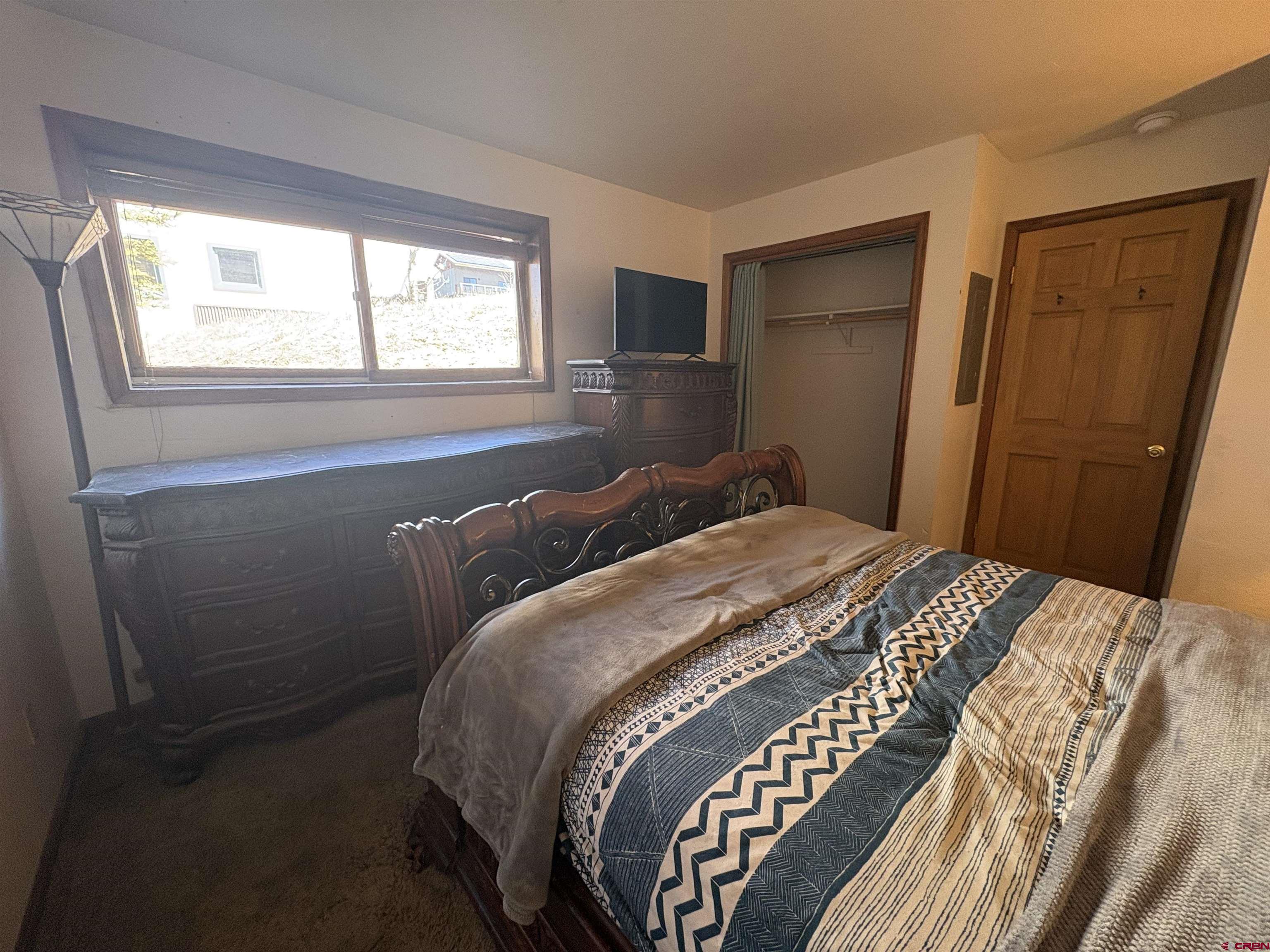 26 Castle Road, Unit 3 Crested Butte, CO 81225 - Photo 26 of 32 a bedroom with a bed and wooden floor